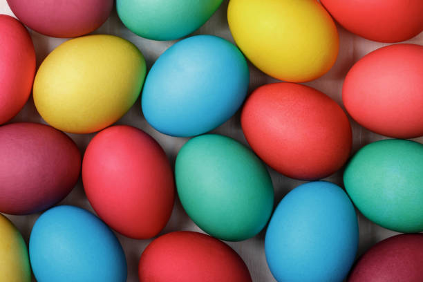 istock A lot of Easter multicolored eggs on a white table.Top view. Close-up 1126485001