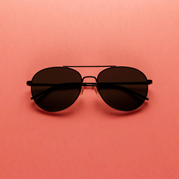 istock Sunglasses on coral background. Top view. Flat lay. Minimal style with colorful paper backdrop. Summer is coming concept. Trend photography on the theme of the new color of the year 2019 - Living Coral 1126485123