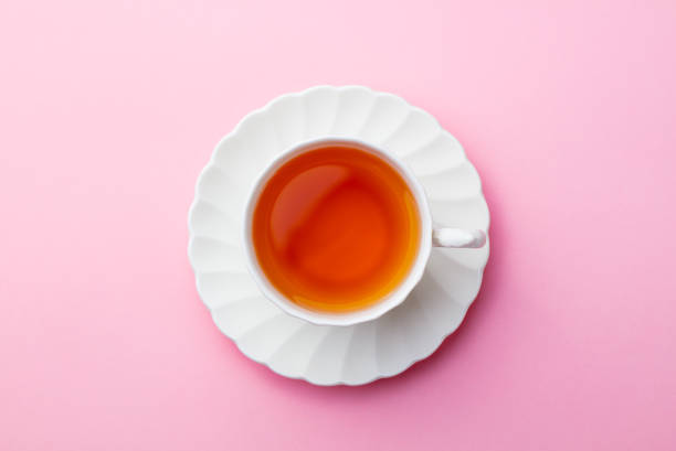 istock Cup of tea on pink background. Top view. Copy space. 1126485746