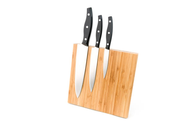 istock Wooden knife holder with three different types of knifes on white background. 1126487503