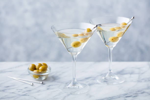 istock Martini cocktail with green olives on marble table background. Copy space. 1126487983