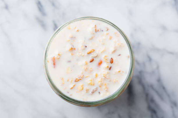 Overnight oats in glass jar on marble table. Top view