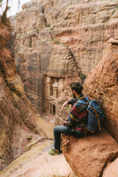 istock Man looking at Al-Khazneh in Petra 1126491421