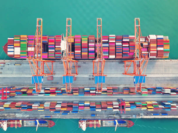 istock Aerial view of international port with crane loading containers. 1126492202
