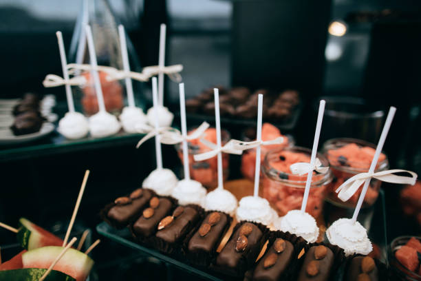 istock Luxury cakes on wedding dessert table in restaurant on the black background 1126494304