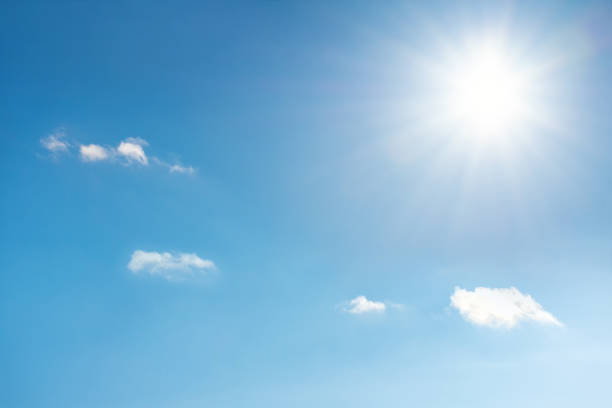 istock Sun with sunrays on the blue sky with white clouds. Daytime and good weather 1126497067