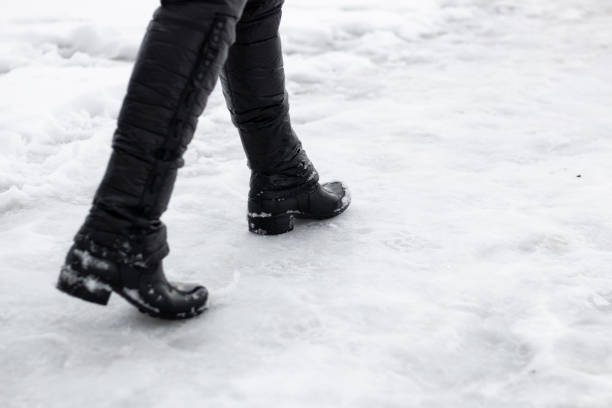 istock Woman's boots in stepping in snow 1126499820