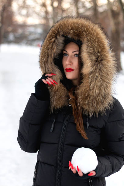 istock Beautiful woman holding snowball 1126500139