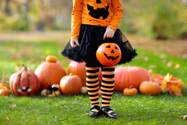 istock Kids with pumpkins in Halloween costumes 1126502068