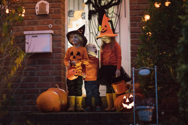 kids with pumpkins in halloween costumes - magic trick imagens e fotografias de stock