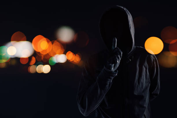 istock Hooded maniac with finger on lips 1126502361