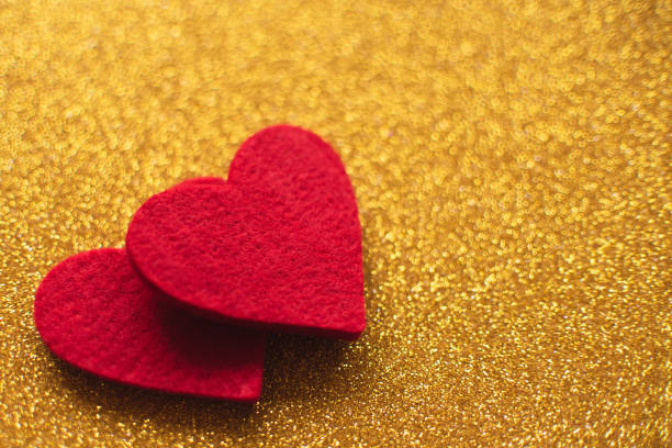 istock Red felt hearts on golden shiny background. Valentine's Day 1126506080