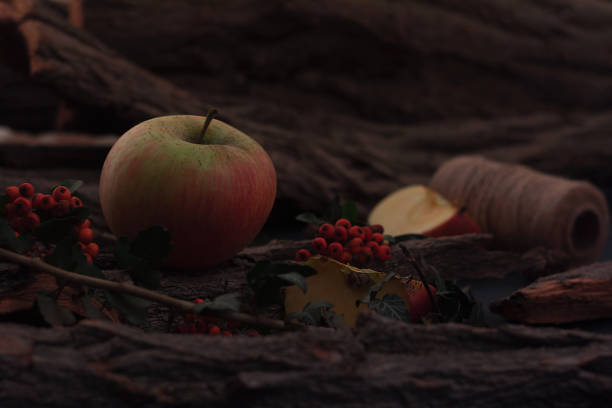 Ripe tasty apples on a wooden table with berries