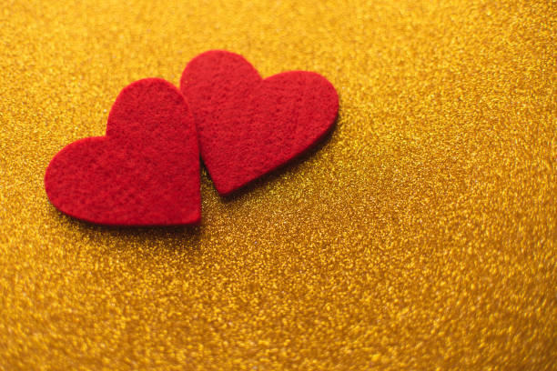 istock Red felt hearts on golden shiny background. Valentine's Day 1126507873
