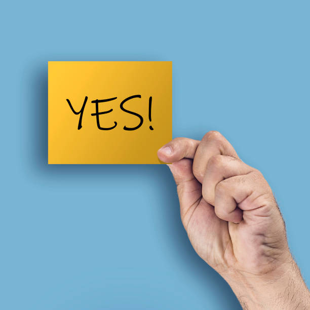 istock Yes. Hand showing or holding card with text 1126507980