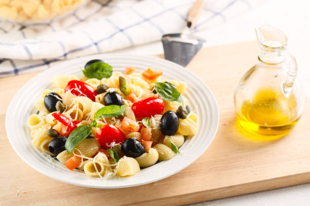 istock traditional Italian pasta Pipe Rigate with tomatoes, olives. 1126509668