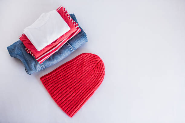 Folded clothes and quilt on bed. Mastercard Creative