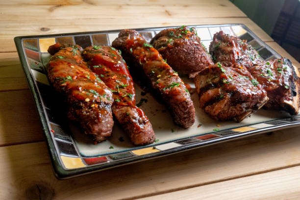 istock Beef Boneless and Bone-in Ribs in Barbecue Sauce on a Rustic Platter 1126510245