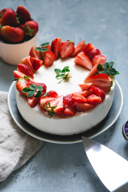 istock Delicate cheesecake with fresh strawberries on a gray background 1126511154