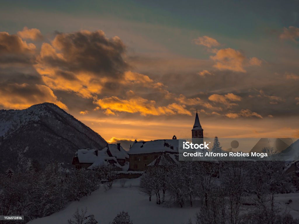 Unha sunset covered by snow Sunset over a mountain village at winter Beauty In Nature Stock Photo
