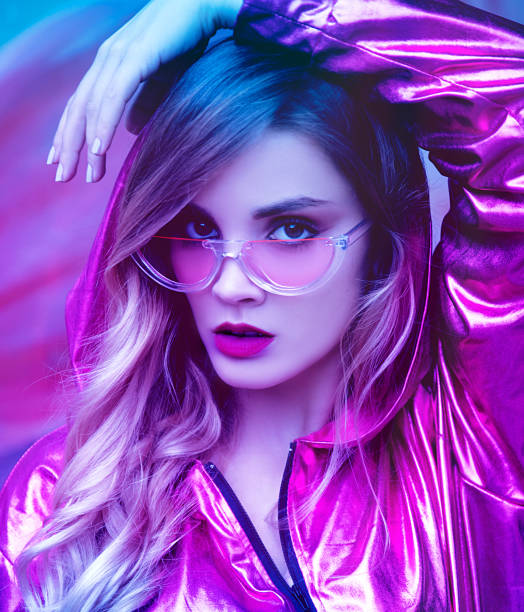 istock Young modern woman in vibrant lights 1126517295