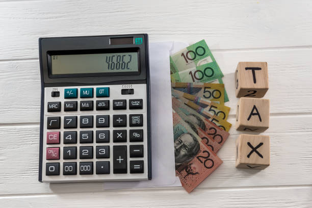 istock Australian dollar banknotes with wooden cubes and calculator 1126518957