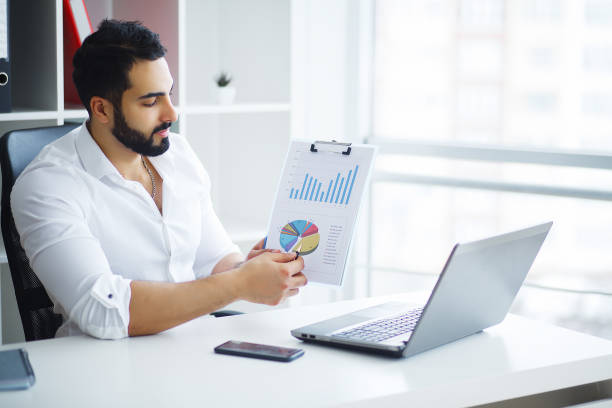 istock Handsome Businessman Working on Laptop at His Office 1126519561