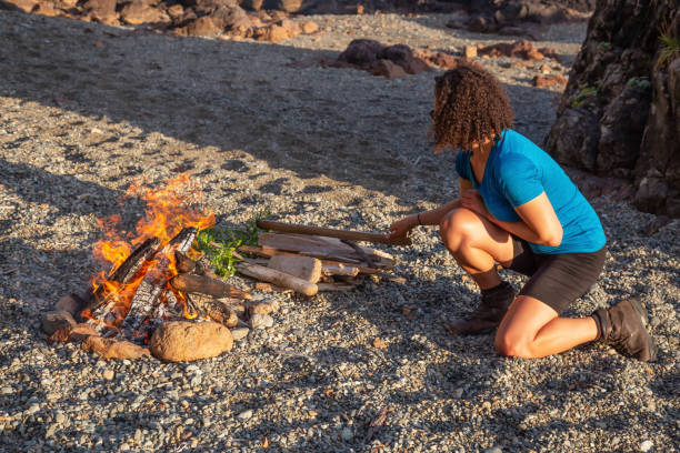 istock Girl by the campfire on the beach 1126521225