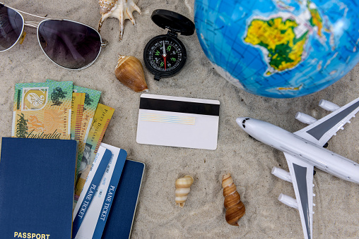 Travelling concept on sand with plane , passport and tickets