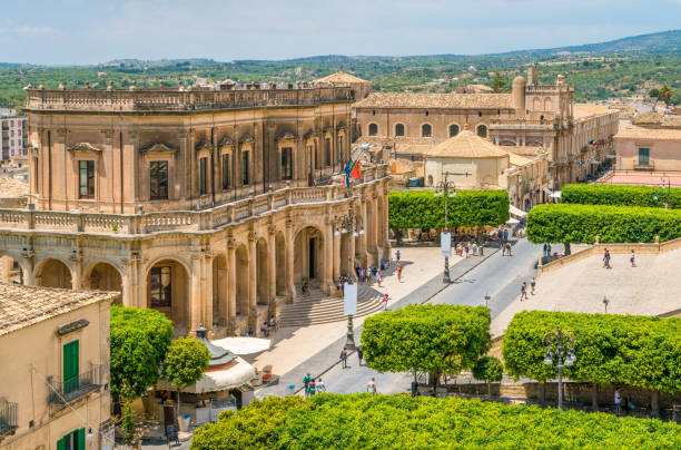 Panoramic view in Noto, with the Palazzo Ducezio and the Church of San Carlo. Province of Siracusa, Sicily, Italy. Panoramic view in Noto, with the Palazzo Ducezio and the Church of San Carlo. Province of Siracusa, Sicily, Italy. noto sicily stock pictures, royalty-free photos & images