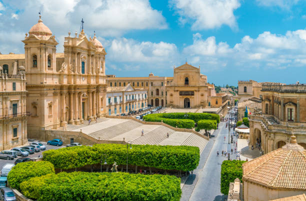 Panoramic view in Noto, with the Cathedral, Palazzo Ducezio and the Santissimo Salvatore Church. Province of Siracusa, Sicily, Italy. Panoramic view in Noto, with the Cathedral, Palazzo Ducezio and the Santissimo Salvatore Church. Province of Siracusa, Sicily, Italy. noto sicily stock pictures, royalty-free photos & images