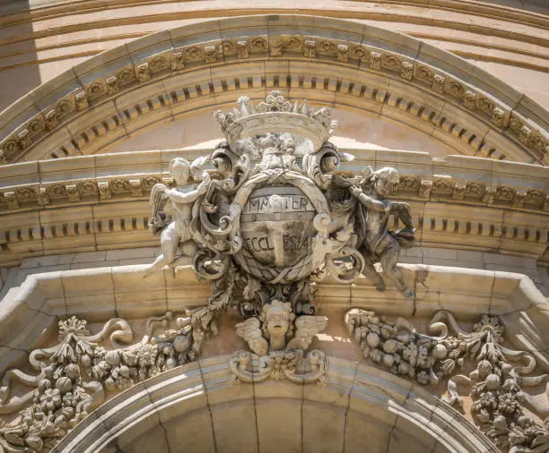 Photo of Emblem over the main gate to the Duomo of Saint George in Rgusa Ibla, Sicily, southern Italy.