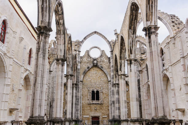 Day view of main nave ruins and arches of The Convent of Our Lady of Mount Carmel, Convento da Ordem do Carmo damaged by 1755 earthquake. stock photo