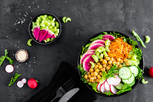 Top view of various multicolored fruits and vegetables disposed side by side at the top of the image on a stripe shape leaving a useful copy space at the bottom on white background