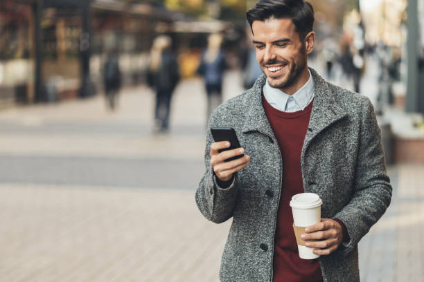 istock Businessman walking and using a smart phone 1126536013