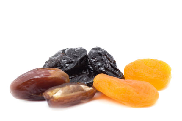 Mix of Ramadan Sweets - Dried fruits and nuts ( apricots, prunes, raisins, walnuts, hazelnuts, almonds, carob, and cinnamon) on sackcloth background