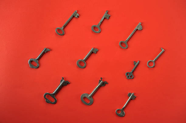 istock vintage key on red background with space for text 1126538859