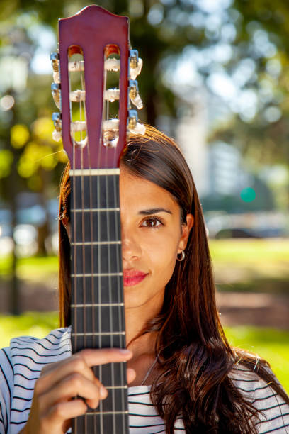 istock Young woman playing guitar 1126539018