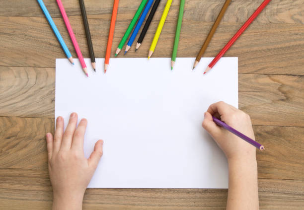 istock Little boy drawing greeting card on table. Father's day concept 1126540696