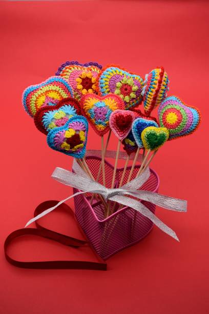 istock Knitted hearts of multi-colored yarn, handmade. 1126540939