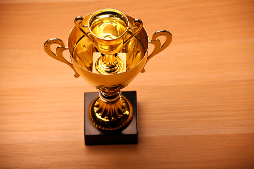A metallic first place cup with label for custom writing