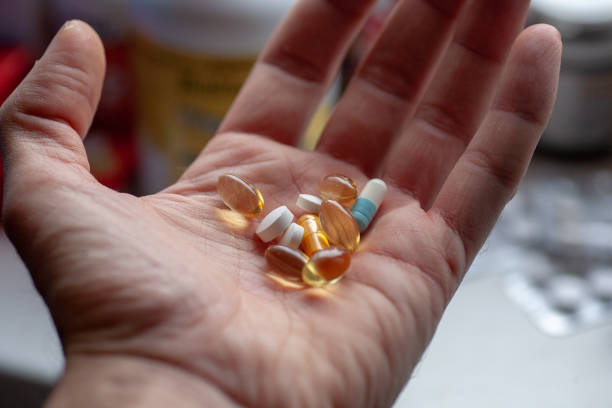 istock Man's hand with a bunch of pills 1126542199