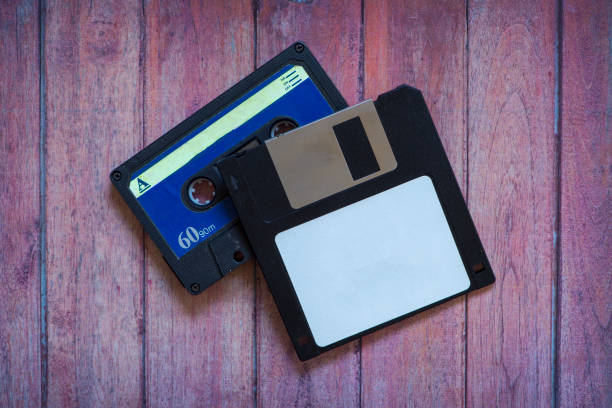 istock Antique diskettes and cassettes on a brown wooden background 1126542549
