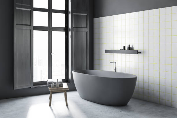 istock White tile bathroom corner, gray tub 1126544104