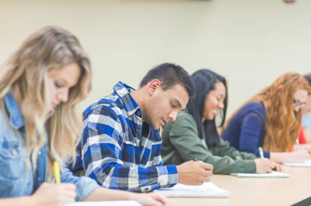 istock College students studying at desks in a lecture hall 1126548800