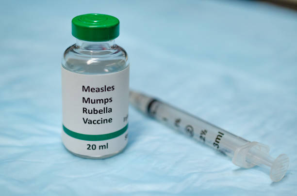 Children vaccine for prevention of viral diseases MMR vaccine holding in hand with injection syringe at the background measles stock pictures, royalty-free photos & images