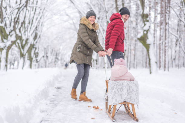 istock Parents are having fun pulling their daughter who is on sleds 1126560073