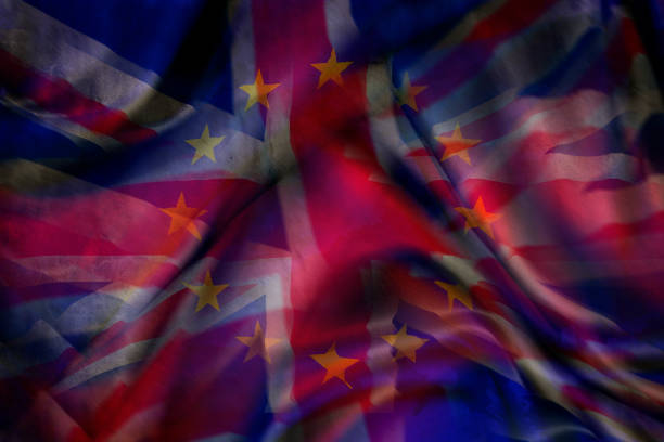 Flags of the European Union and the United Kingdom of Great Britain illustrating a chaotic Brexit scenario when the UK leaves the EU