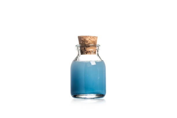 istock Studio shot of glass bottle with blue liquid isolated on white 1126564670