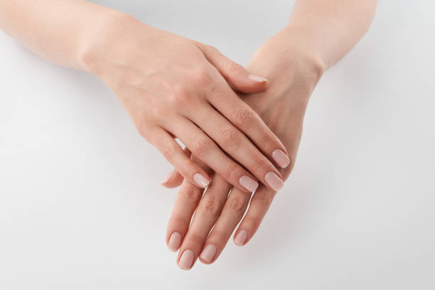 istock Partial view of female well-cared clanched hands on white background 1126565361